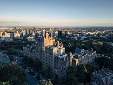 Bulutlu bir gökyüzüne karşı düşük açılı mavi kıvrımlı metal bir duvar gösteren minimal mimari bir kompozisyon. Görüntü endüstriyel tasarım, yapı ve geometrik dokuyu vurgular
