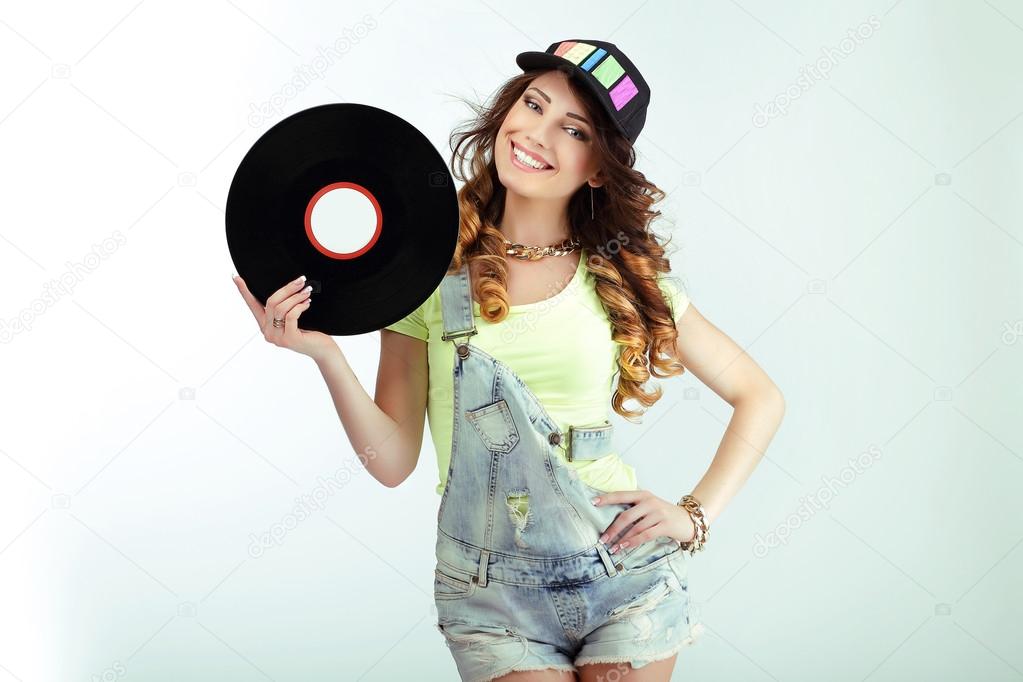Amusement. Funny Woman holding Vinyl Record and Smiling