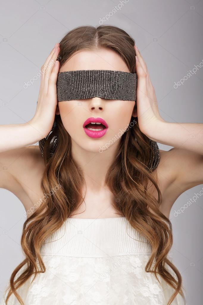 Confusion. Woman holding Headband on her Head