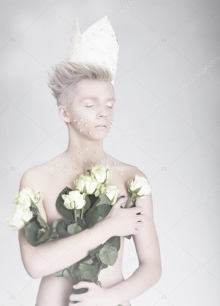 Artistry. Trendy Young Man in Paper Crown with Flowers