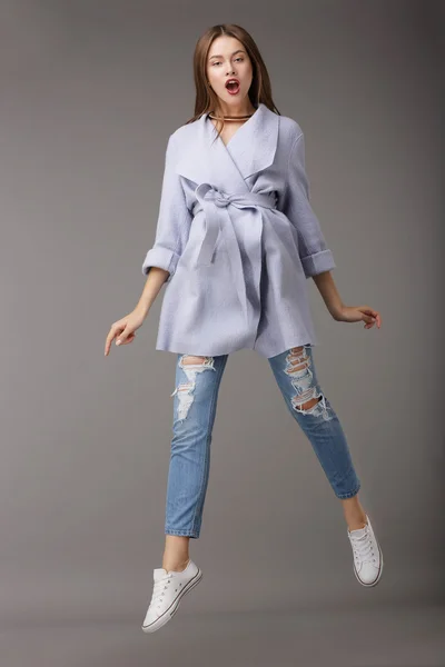 Trendy Young Female Jumping in Blue Coat — 图库照片