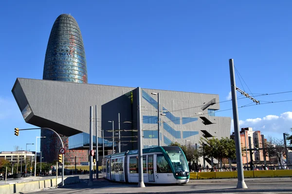 Modern tram in Barcelona near Agbar Tower, Spain