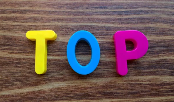 The word Top on a wooden background — Stock Photo, Image