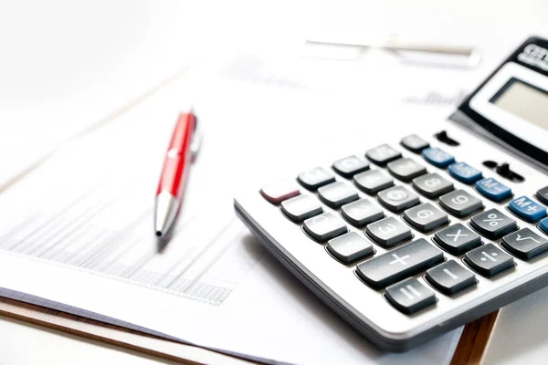 Finans ve iş konsepti. Masadaki mali grafiklerde hesap makinesi var. Muhasebe bütçe kredileri veya piyasa analizi.