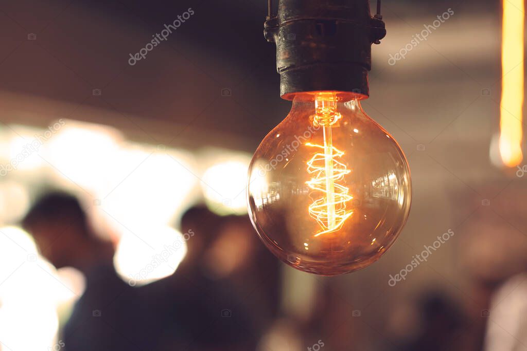 Close-up of incandescent light bulbs hanging in the dark room. Decorative antique edison light bulbs with straight wire. Dimmable, warm white, E27