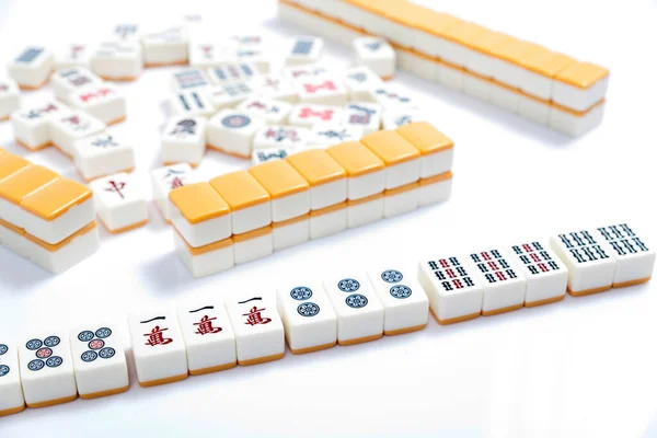 Mahjong game on white table, close up.