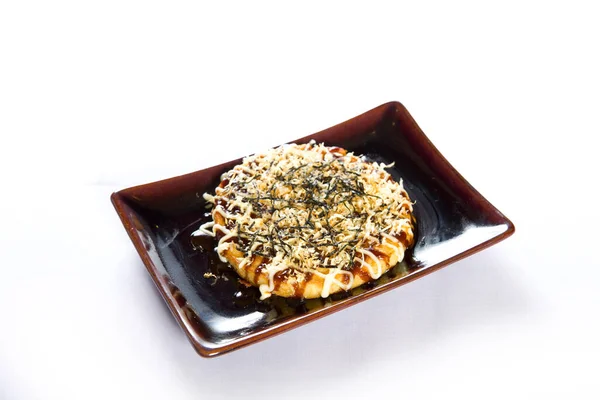 Japanese traditional pancakes (Okonomiyaki) on white background.