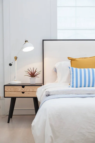 Beyaz, sarı ve mavi yatak odalı yan masa lambası..