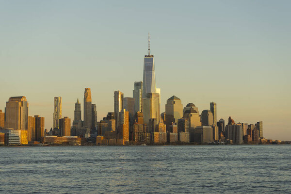 New York City, Manhattan skyline at sunset over Hudson River viewed from New Jersey.