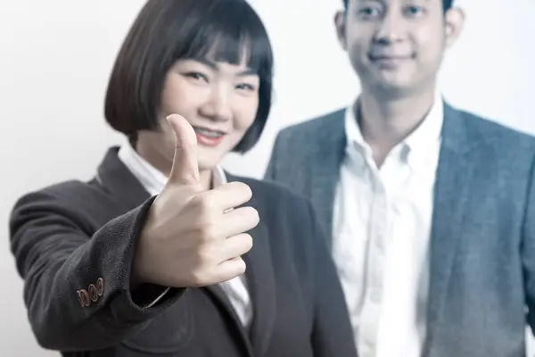 Happy business man and woman in worker suit showing thumb up sign stand over white background.