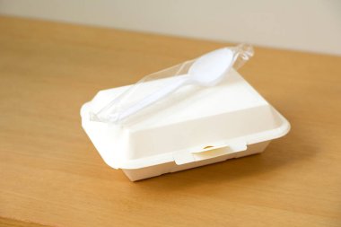 Service food delivery box or take away boxes, disposable eco friendly food packaging containers with spoon and fork on wooden table at home