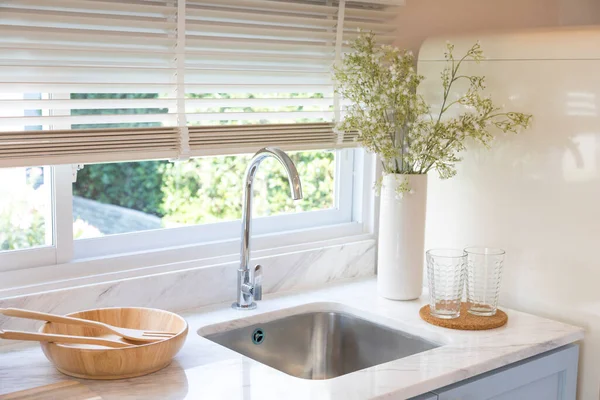 New sink and modern tap in stylish kitchen. Luxury new kitchen with marble top. Modern kitchen interior.