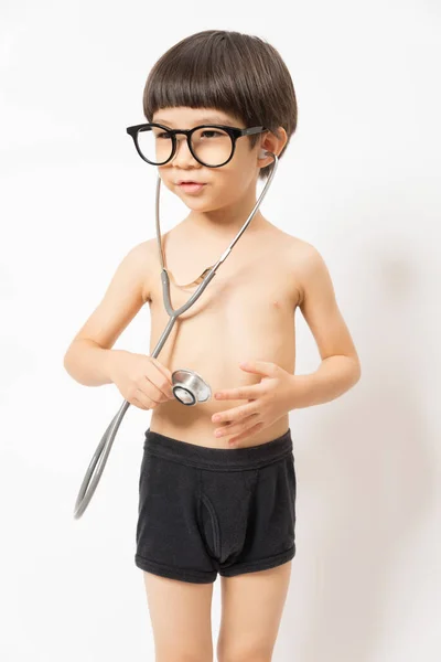 Asiatischer Junge Mit Brille Lächelt Und Spielt Stethoskop Auf Weißem — Stockfoto