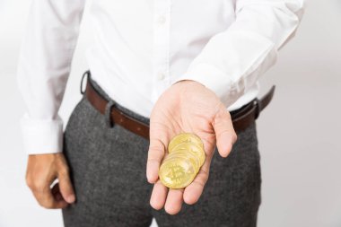close up of man hand holding bitcoin on white background.