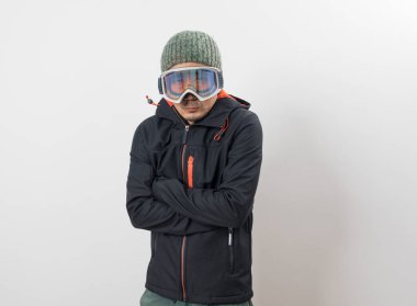Kışlık ceketli, gözlüklü ve eldivenli beyaz arka planda snowboardcu için giyinmiş Asyalı bir adam..