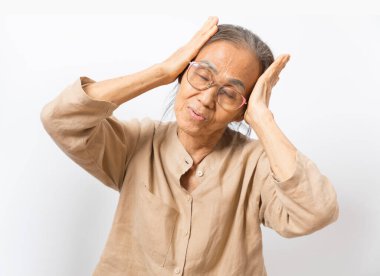 Senior asian women feeling headache, thinking of problems stand on white background.
