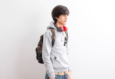 young student boy with backpack and books on white background