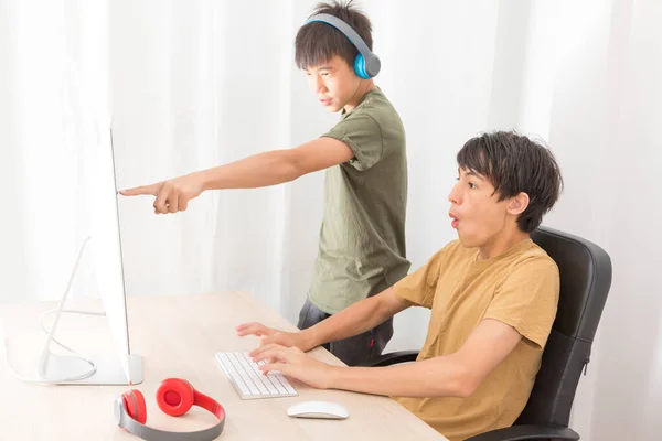 Two Teenage Boys Headphone Using Computers Play Online Gaming Home — Stock Photo, Image