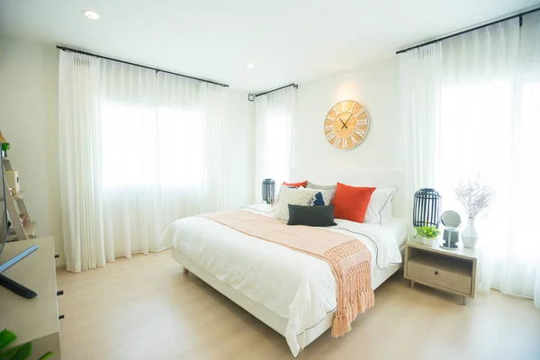 interior of a modern bedroom with a clock on the wall