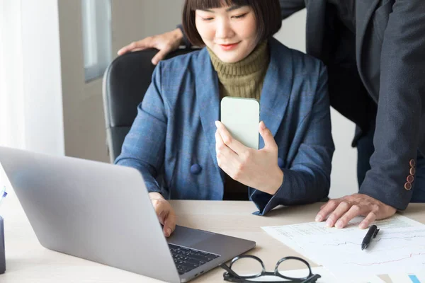 Young Asian Woman Talking Smartphone Typing Laptop While Working Male — ストック写真