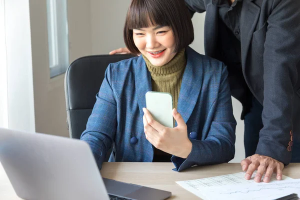 Young Asian Woman Talking Smartphone Typing Laptop While Working Male — ストック写真