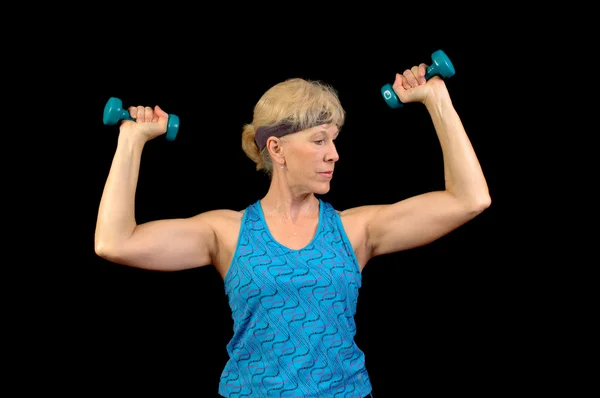 Baby-boomer exercising with weights — Stock Photo, Image