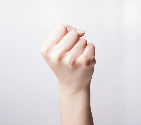Hand clenched in front of the camera over white background — Stock Photo, Image