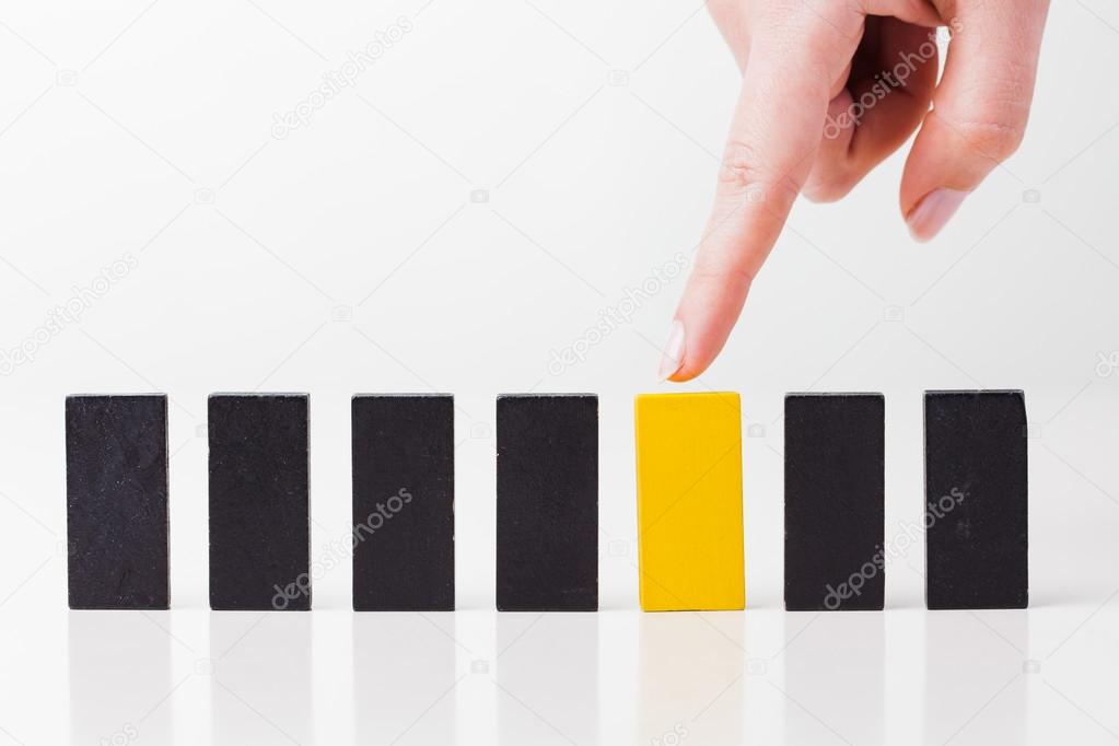 A human hand shows at the domino game. All isolated on white bac