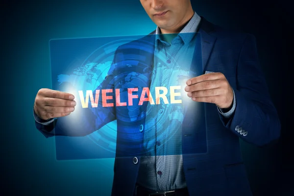 Businessman holding a transparent screen with an inscription a w — Stock Photo, Image