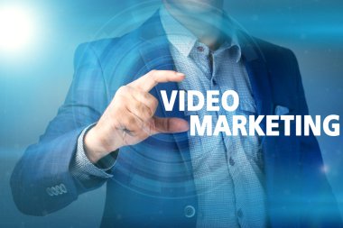 Businessman presses button video marketing on virtual screens. B clipart