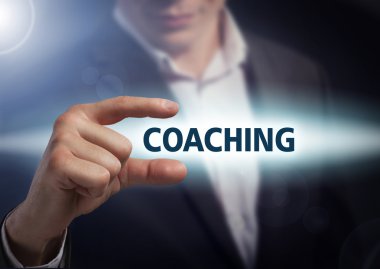 Businessman presses button coaching on virtual screens. Business