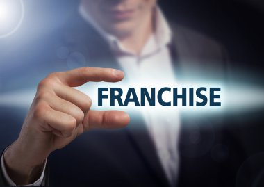 Businessman presses button  franchise on virtual screens. Busine