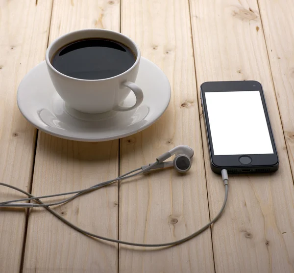 Headphones and a cup of coffee — Stock Photo, Image