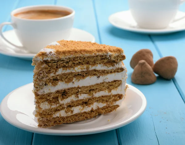 Piece of cake on blue wooden table — Stock Photo, Image