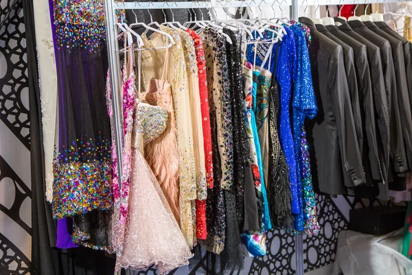 shiny dresses and suits hanging on the hanger