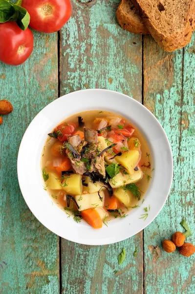 Homemade chorba soup with lamb meat on bone, potato, carrots — Stock Image Homemade chorba soup with lamb meat on bone, potato, carrots Royalty Free Stock Images