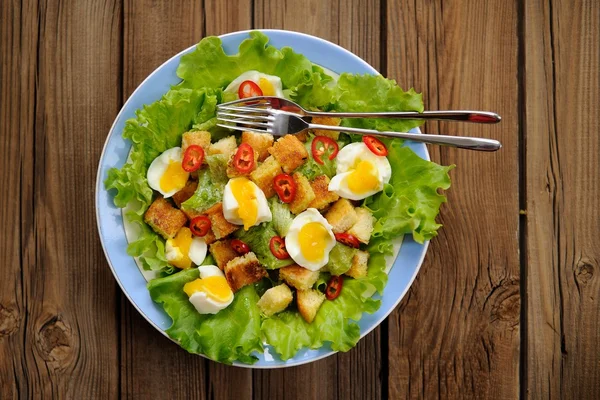 Salad Caesar with eggs, chili pepper and two forks top view — Stock Image Salad Caesar with eggs, chili pepper and two forks top view Stock Picture