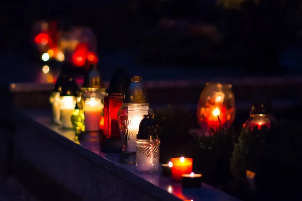 Flaming colored candle on the grave — Stock Photo, Image