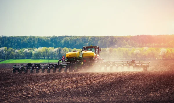 Tractor plowing farm field in preparation for spring planting. — Stock Photo, Image