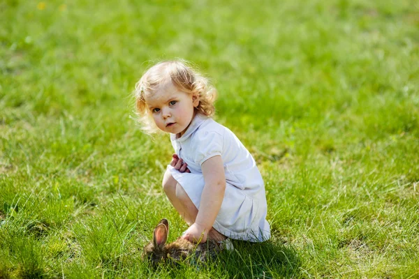 Child with a rabbit on the grass — Stock Photo, Image