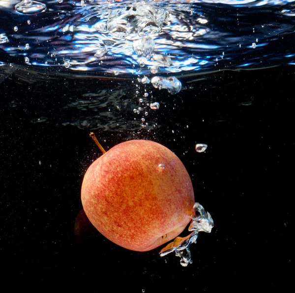 Apple in water with bubbles — Stock Photo, Image