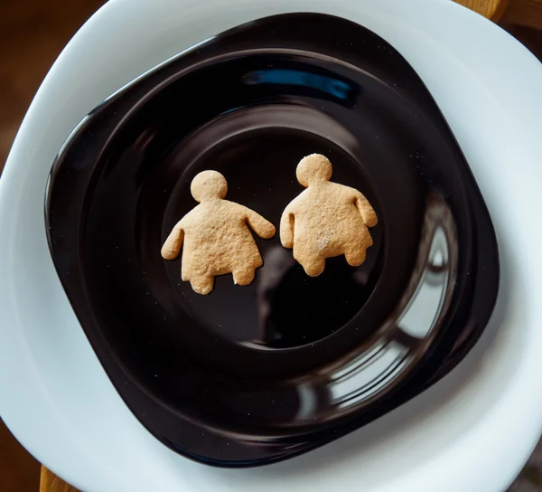 Pile of  cookies on a black plate — Stock Photo, Image