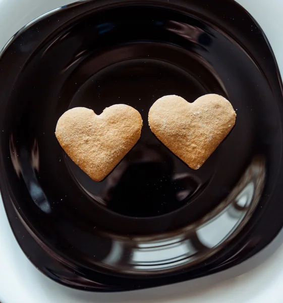 Pile of  cookies on a black plate — Stock Photo, Image