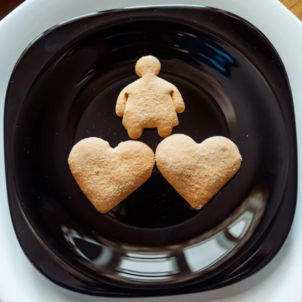 Pile of  cookies on a black plate — Stock Photo, Image