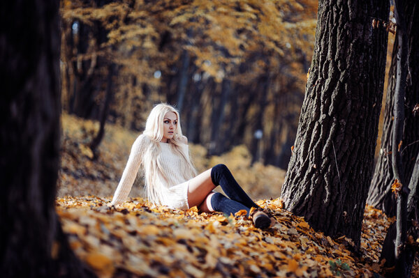 Portrait of beautiful young woman outdoors in autumn