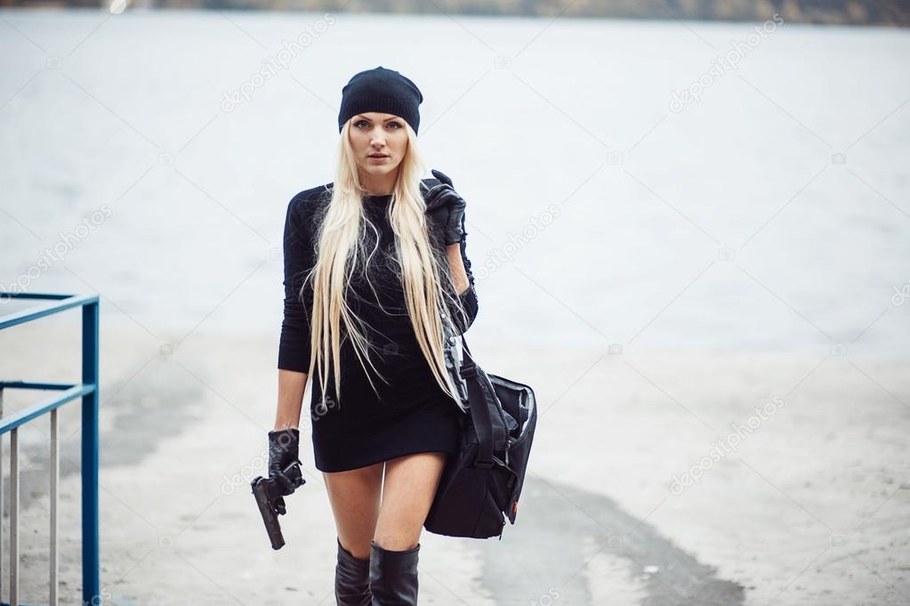 Sexy blonde girl with weapon