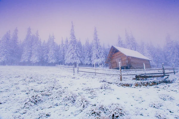 Sunset in the winter mountains and fantastic chalet — Stock Photo, Image