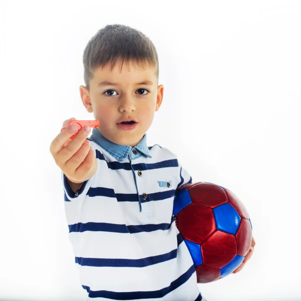 Caucasian boy holding a soccer ball and whistle — Stock Photo, Image