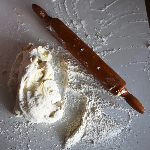 Rodillo de madera con harina de trigo blanco sobre la mesa — Foto de Stock