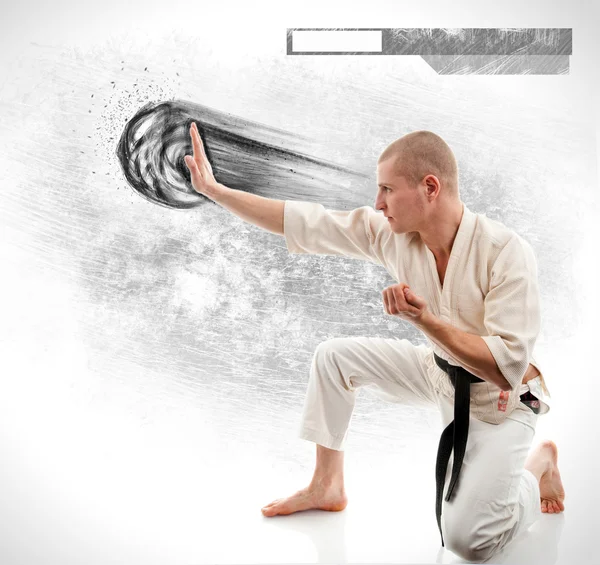 Karate. Man in a kimono on the white background — Stock Photo, Image